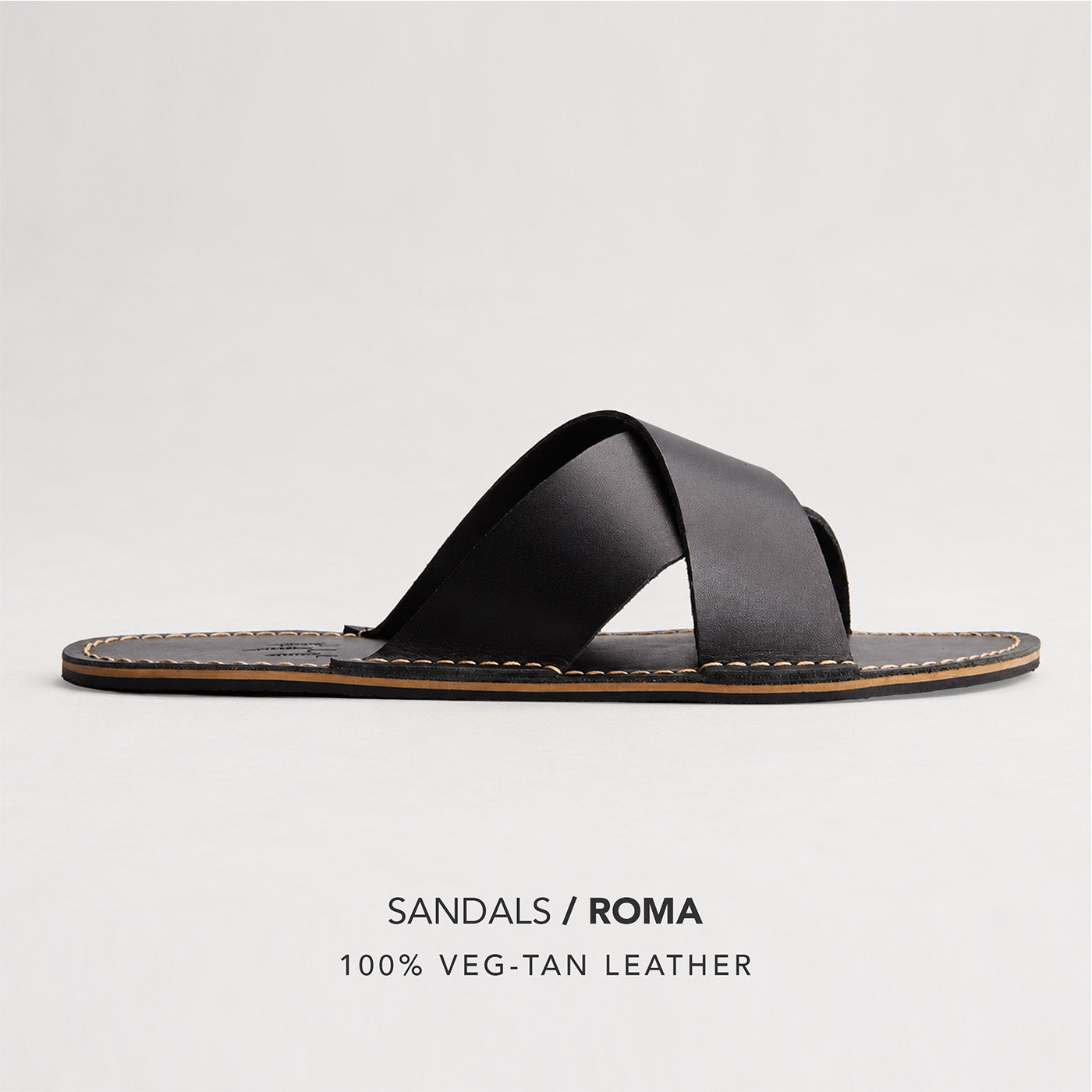 Nero | Flat leather sandal with debossed PLG three tree logo in sole, text reads "Sandals Roma 100% Veg Tan Leather"