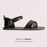 Nero | Flat leather sandals with ankle straps and debossed PLG three tree logo in soles, shown on a light gray background with text below reading 'SANDALS / VENEZIA' and '100% VEG-TAN LEATHER'.