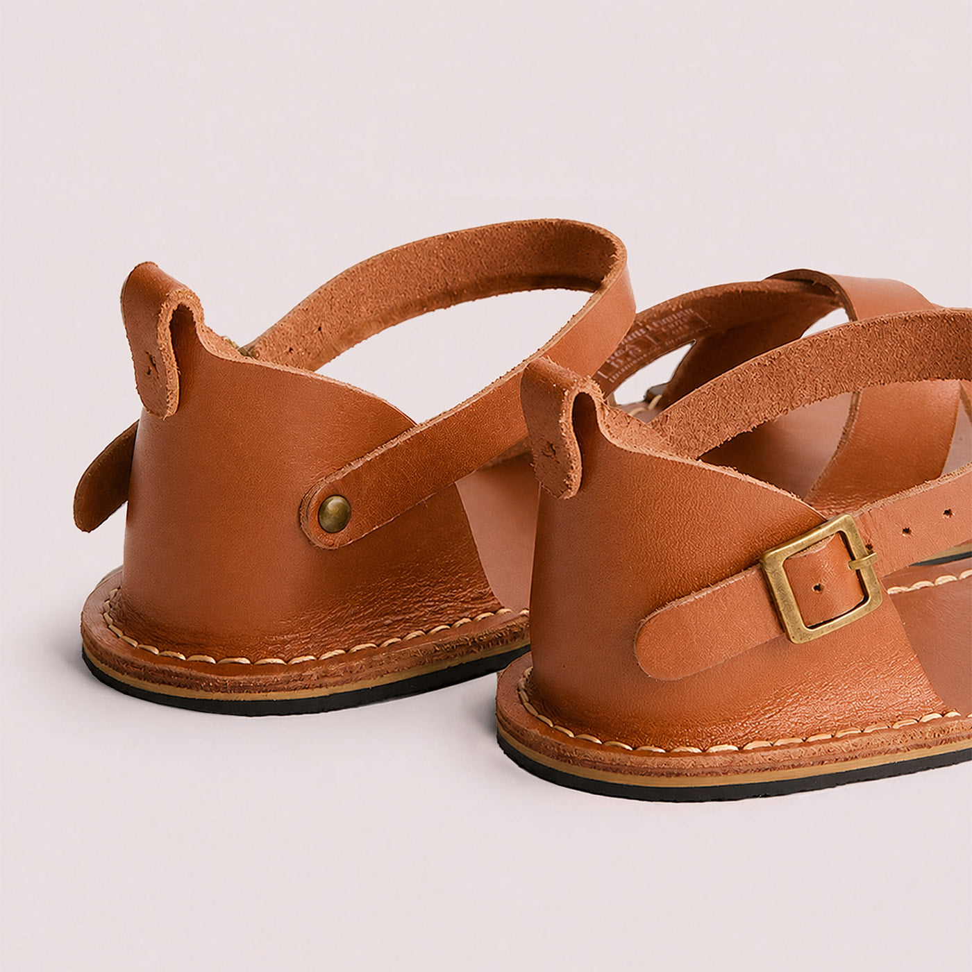 Miele | Flat leather sandals with ankle straps and debossed PLG three tree logo in sole