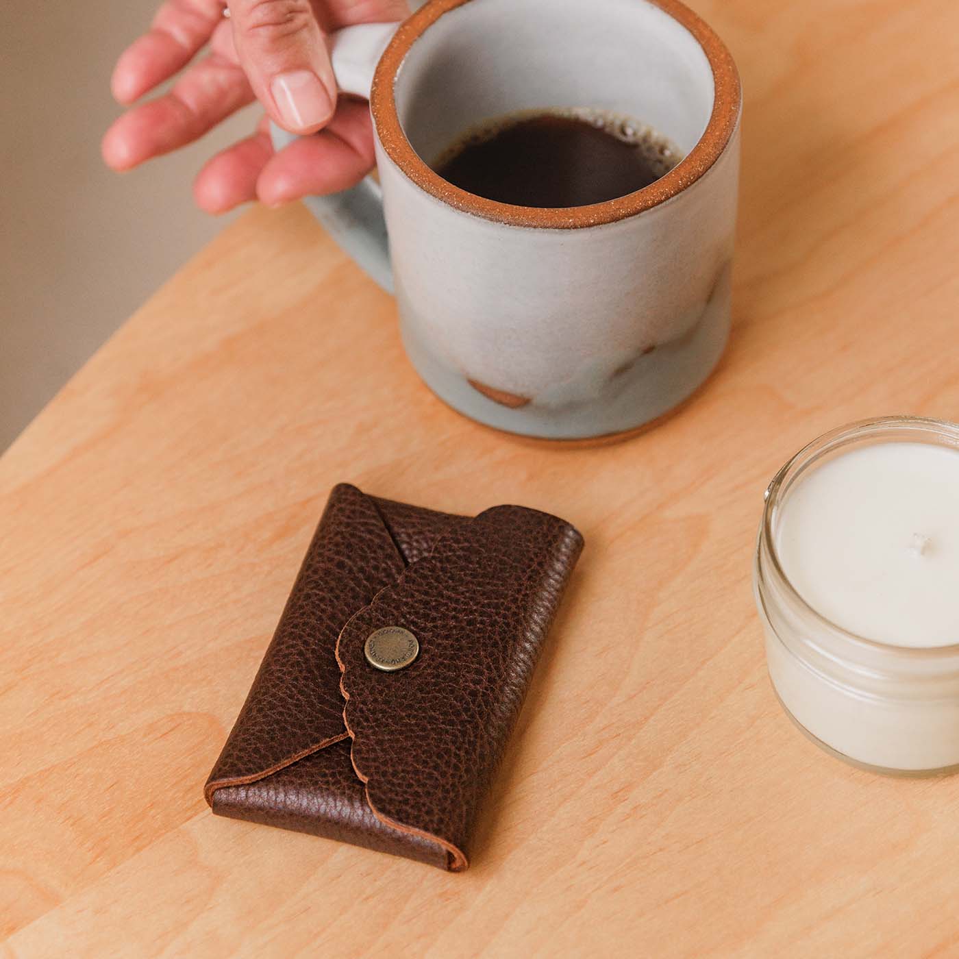Coldbrew |  Small leather wallet with scalloped edge next to coffee mug