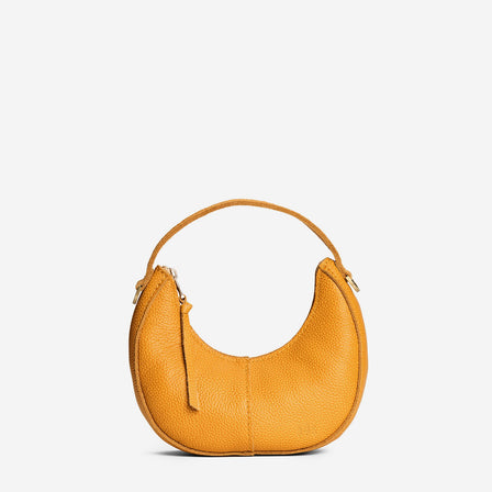 Sunshine | Crescent shaped shoulder bag with zipper closure and gold accents