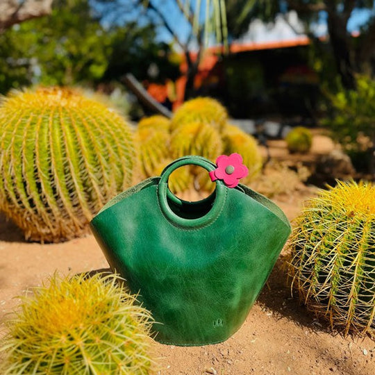 A Cowboy Mint Milan bag sitting in amongst cactus