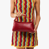 Chili Red | Model holding a red bowler style hand bag 