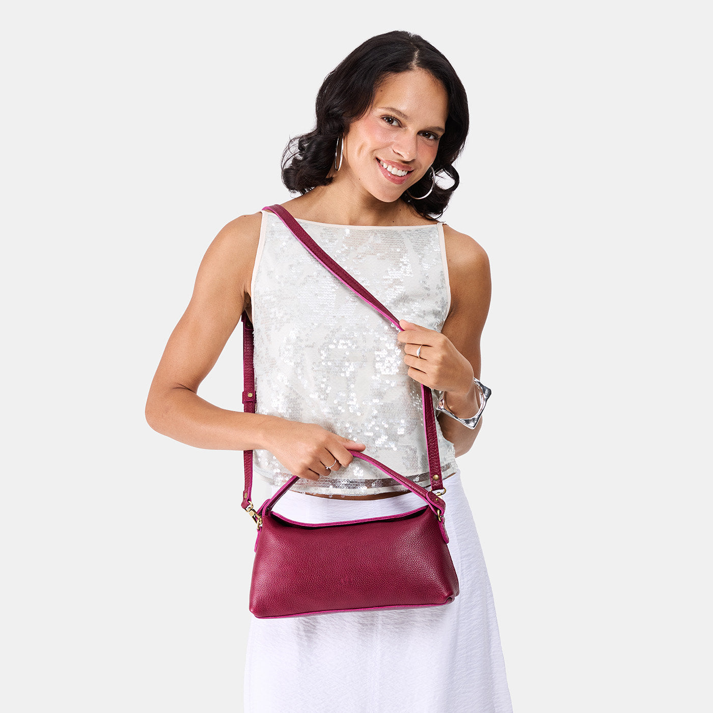 Orchid | Model holding a dark brown colored bowler style hand bag