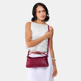 Orchid | Model holding a dark brown colored bowler style hand bag