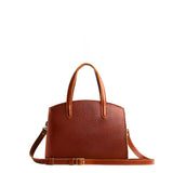 Nutmeg Medium | Leather tote bag with handles, adjustable crossbody strap, zipper top, and two back pockets