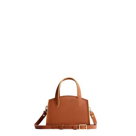 Honey*Medium | Leather tote bag with handles, adjustable crossbody strap, zipper top, and two back pockets