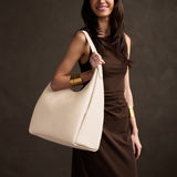 Pebbled Bone Oversized | U-shaped, flat-bottomed leather shoulder bag with adjustable strap