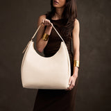 Pebbled Bone Oversized | U-shaped, flat-bottomed leather shoulder bag with adjustable strap