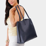 Night Owl Large | Model holding leather tote bag with interior snap key loop