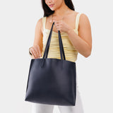 Night Owl Large | Model holding leather tote bag with interior snap key loop