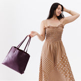 Plum Large | Model holding leather tote bag with interior snap key loop