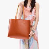 Sienna Large | Model holding leather tote bag with matching leather handles