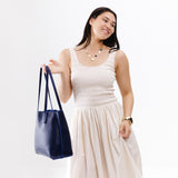Cobalt Medium | Model holding leather tote bag with interior snap key loop