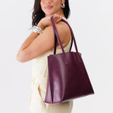 Lollipop Medium | Model holding leather tote bag with interior snap key loop