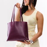 Lollipop Medium | Model holding leather tote bag with interior snap key loop