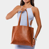 Meadow Medium | Model holding leather tote bag with interior snap key loop