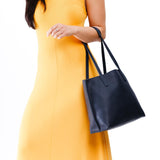 Night Owl Medium | Model holding leather tote bag with interior snap key loop