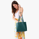 Sea Glass Medium | Model carrying leather tote bag with matching leather handles
