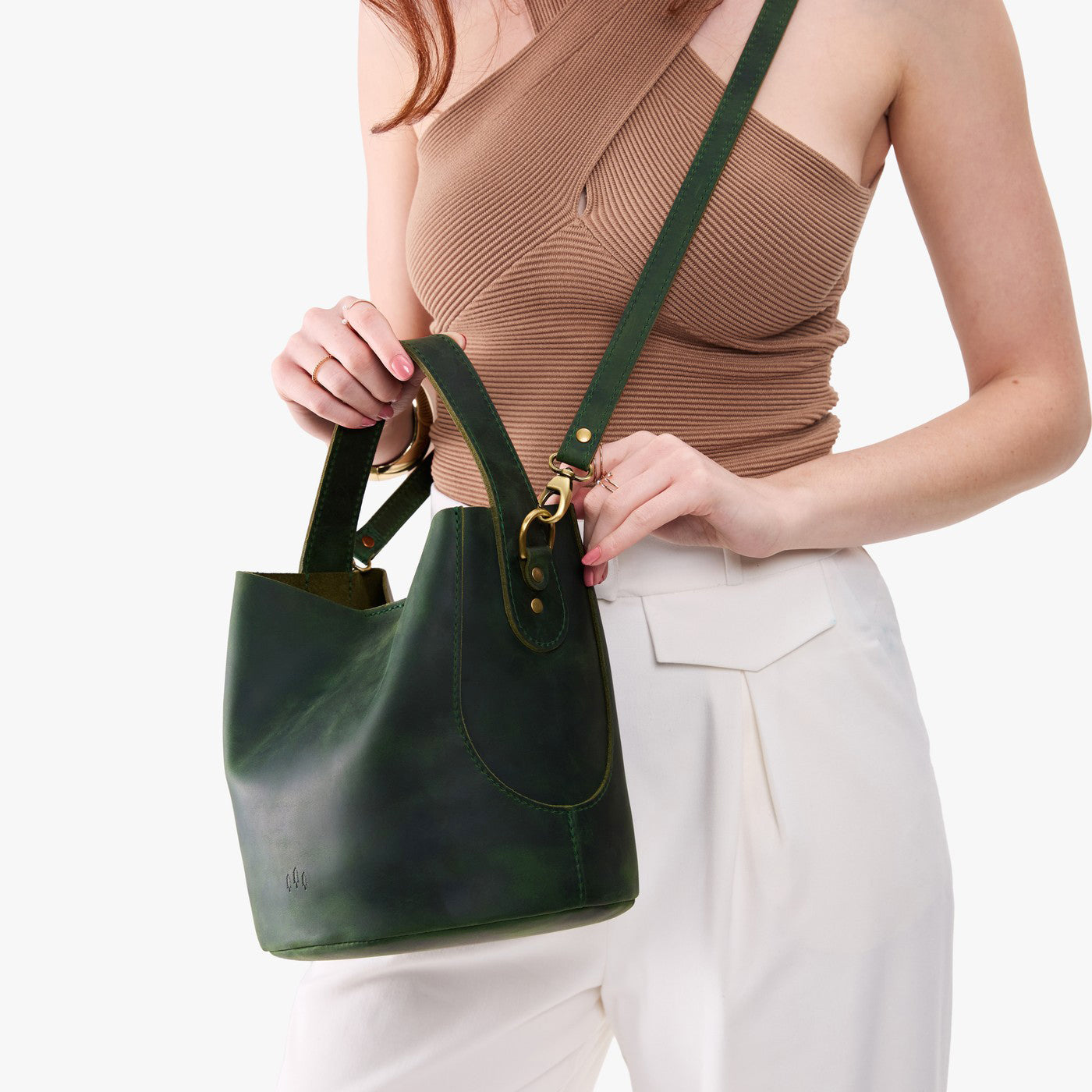 Evergreen*Large | Model holding symmetrical bucket bag with handle, latch closure, and removable crossbody strap