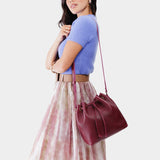 Orchid Large | Model wearing slouchy crossbody bag with drawstring closure