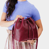 Orchid Large | Model holding slouchy crossbody bag with drawstring closure