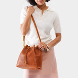 Sienna Large | Model holding slouchy crossbody bag with drawstring closure
