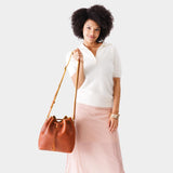 Sienna Large | Model holding slouchy crossbody bag with drawstring closure