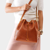 Sienna Large | Model holding slouchy crossbody bag with drawstring closure