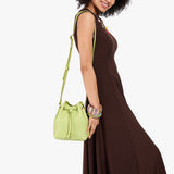 Shadow Lime Small | Model wearing slouchy crossbody bag with drawstring closure