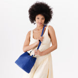 Joni Blue | symmetrical bucket bag with latch closure and removable crossbody strap
