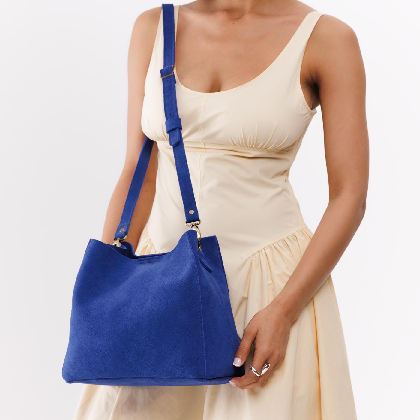 Joni Blue | symmetrical bucket bag with latch closure and removable crossbody strap