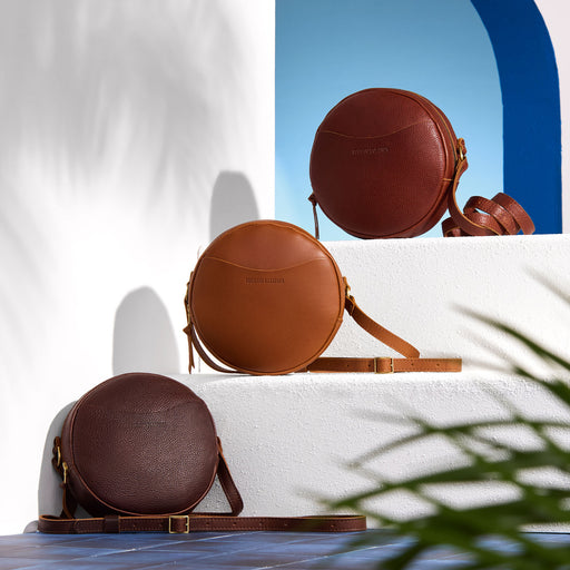 Three Circle Crossbody bags on a white surface with a blue arch in the background featured image