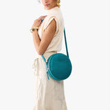 Aquarius Large | Model wearing circle shaped crossbody bag with top zipper