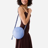 Aster Large | Model wearing circle shaped crossbody bag with top zipper