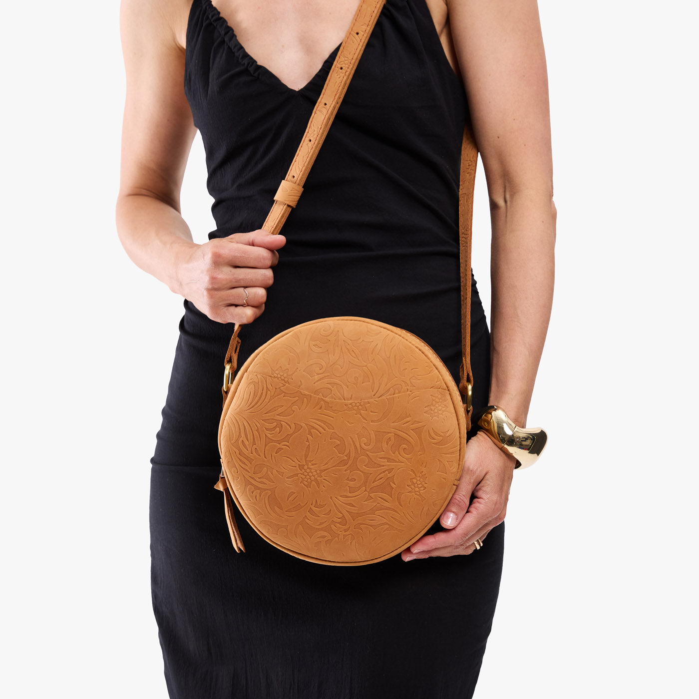 Desert Flower | Model wearing a large circle shaped crossbody bag with top zipper
