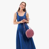 Hollyhock | Model wearing a large circle shaped crossbody bag with top zipper