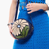 Wildflower Cobalt Small | Model holding circle shaped crossbody bag with top zipper