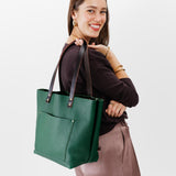 Bacalar Classic  | Model holding large leather tote bag with sturdy bridle handles and front pocket