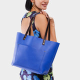 Astro Blue Classic | Model wearing large leather tote bag with sturdy bridle handles and front pocket