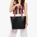 Black Classic | Leather Tote Bag with bridle leather handles being held by a model