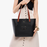 Black Classic | Leather Tote Bag with bridle leather handles and monogram plate being held by a model