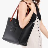Black Classic | Leather Tote Bag with bridle leather handles and monogram plate being held by a model