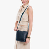 Boreal | Model wearing rectangular side bag with curved front pocket and metal tree shaped badge