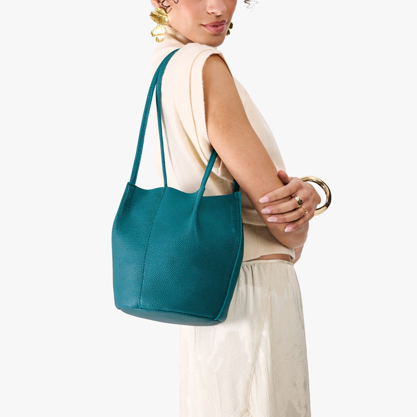Aquarius*Classic | Model wearing matching white shirt and skirt carrying petite bucket shaped tote bag with matching leather handles