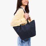 Alaska Blue Large | Model holding wide bucket shaped tote bag with matching leather handles