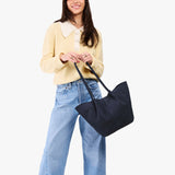 Alaska Blue Large | Model holding wide bucket shaped tote bag with matching leather handles