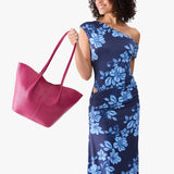 Cosmo Large | Model wearing blue floral patterned dress holding wide bucket shaped tote bag with matching leather handles