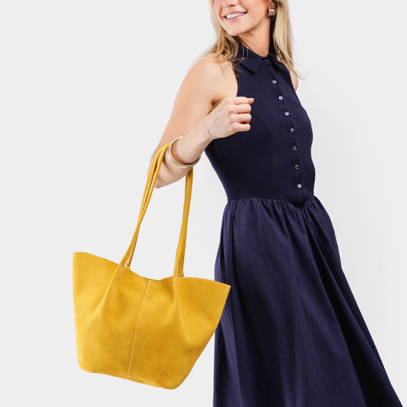Hello Yellow*Large | Model holding wide bucket shaped tote bag with matching leather handles