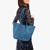 Mariner Blue Large | Model holding wide bucket shaped tote bag with matching leather handles
